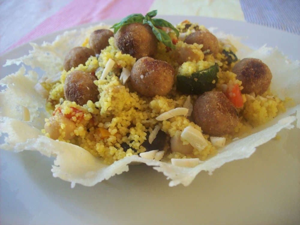 Couscous with spicy meatballs, vegetables and chickpeas in double Parmigiano Reggiano crust baskets - Morocco